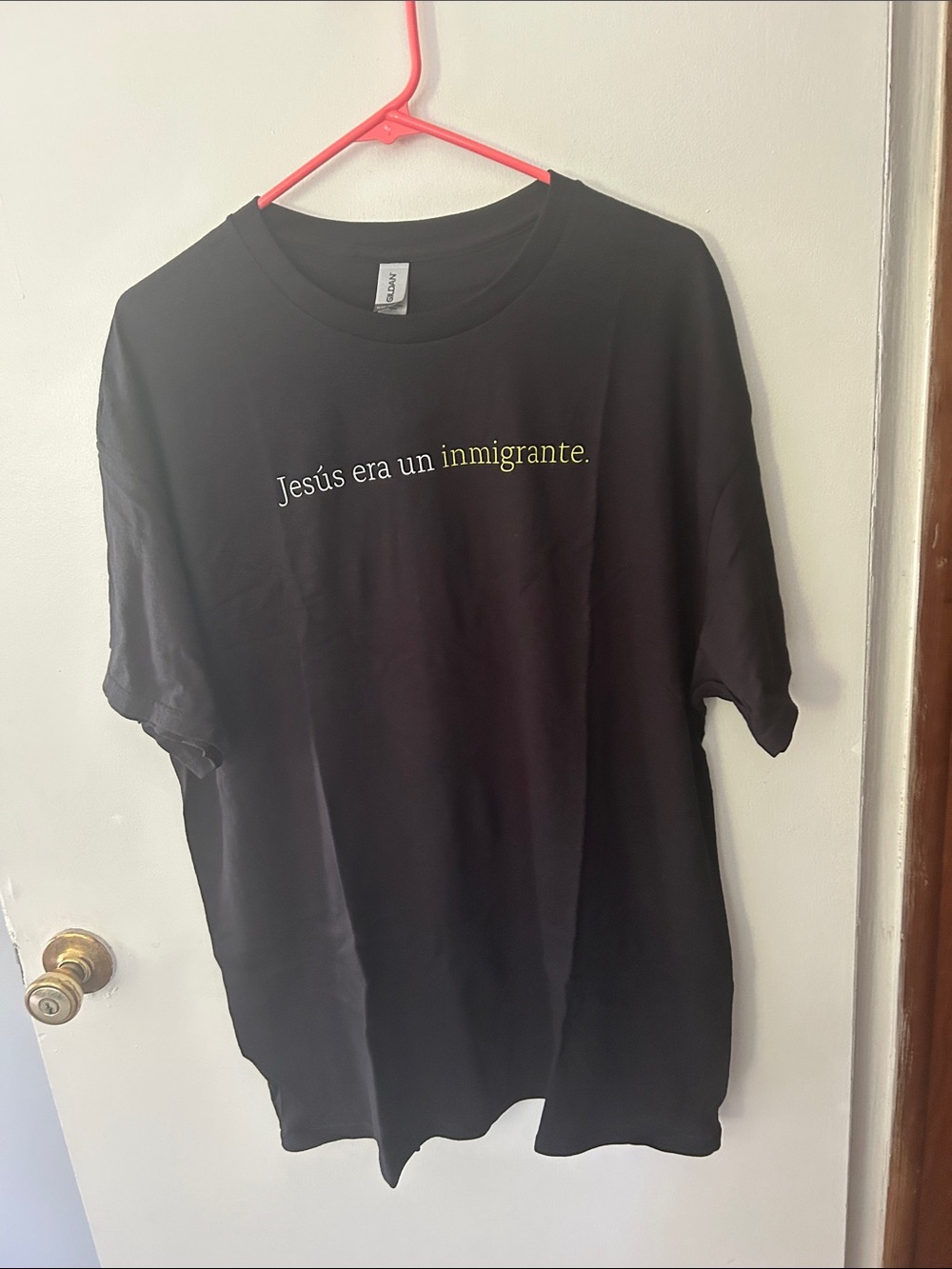 Gildan Black Jesus Era Un Inmigrante Tee with Yellow & White Text